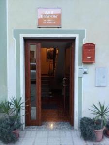an entrance to a building with a sign over the door at Bed and Breakfast Bellavista in Olmedo