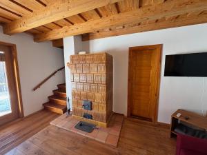 a living room with a fireplace and a tv at Frida Farm Vendégház in Kétvölgy