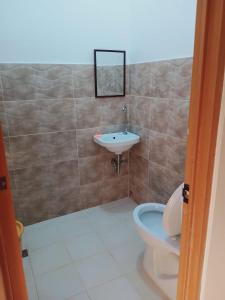 a bathroom with a toilet and a sink at Jarens Diner in Silang