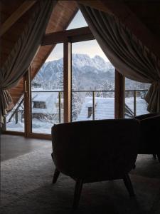 a couch in a room with a view of a mountain at Nova Hill in Zakopane