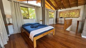 a bedroom with a bed in a room with windows at Montezuma Hills - Twin Houses in private compound - 4' to Downtown in Montezuma
