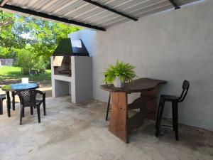 a patio with a table and chairs and a table and chairs at AlojaMenta in Nono