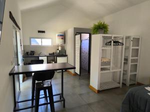a kitchen with a table and chairs in a room at AlojaMenta in Nono +2 photos