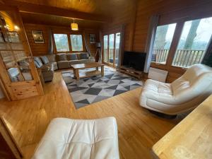 a living room with a couch and a table at The Fairways, Kenwick Retreats in Louth