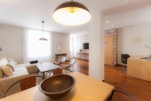 a living room with a couch and a table at Vincci Soma in Madrid +74 photos