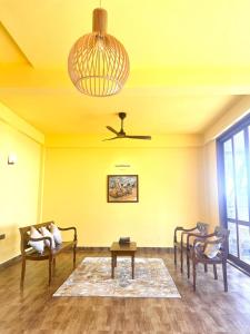 a living room with a couch and a ceiling fan at CocoBaru - Private Beachfront Entire Villa in Marawila