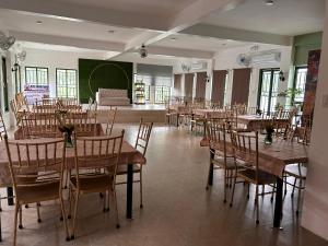 a dining room with wooden tables and chairs at Jarens Diner in Silang +15 photos