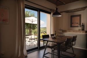 a dining room with a table and chairs and a patio at Tenuta Dei Vicini - Luxury Apartments in San Marzano Oliveto