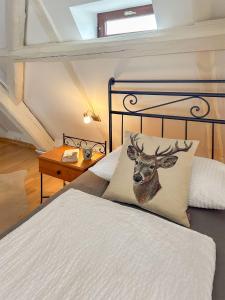 a bedroom with a bed with a picture of a deer pillow at Ferienwohnungen Elbjuwel in Rathen
