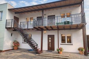 a house with a staircase and a balcony at Dunes Trail 4 in Melnragė