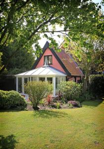 a red and white house with a window at 1 Bed in Frostenden oc-phc in Frostenden