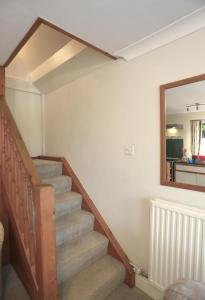 a staircase in a house with a mirror at 1 Bed in Frostenden oc-phc in Frostenden