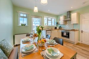 a kitchen and dining room with a wooden table with food at 3 Bed in Braunton oc-b29581 in Braunton