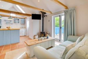 a living room with a white couch and a kitchen at 1 Bed in Biddenden oc-cb635 in Biddenden