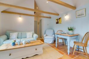 a living room with a couch and a table at 1 Bed in Biddenden oc-cb635 in Biddenden