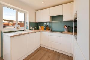 a kitchen with white cabinets and a window at 2 Bed in Walcott oc-2301 in Walcott