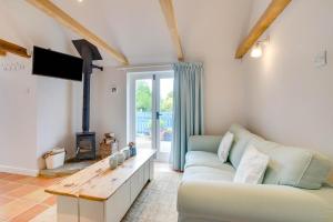 a living room with a couch and a fireplace at 1 Bed in Biddenden oc-cb635 in Biddenden