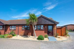 a brick house with a palm tree in the driveway at 2 Bed in Walcott oc-2301 in Walcott