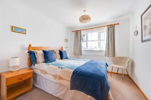 a bedroom with a bed and a chair and a window at 2 Bed in Walcott oc-2301 in Walcott