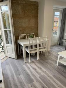 a dining room with a table and two chairs at Ponte Romana in Chaves