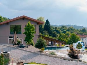 a villa with a swimming pool and a house at Villa Valentina b&b in Vicoforte