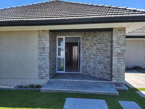 a front door of a home with a brick wall at Wagenaar Villas in Monte Vista