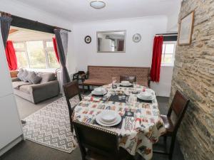 a dining room with a table and a couch at Maesgwyn in Cardigan