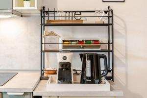 a coffee maker on a shelf in a kitchen at Casa al Castagneto in Trento +12 photos