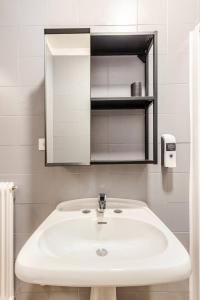a bathroom with a white sink and a mirror at Casa al Castagneto in Trento
