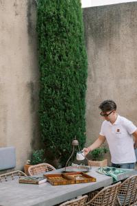 a man standing in front of a table with a table at Zacosta Villa - a Heritage Hotel in Rhodes Town