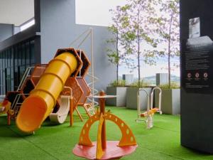 a playground in a building with a slide at ImpianKU MetaStay KL in Seri Kembangan