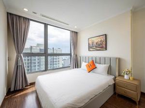 a bedroom with a bed and a large window at SG lusxury city in Ho Chi Minh City