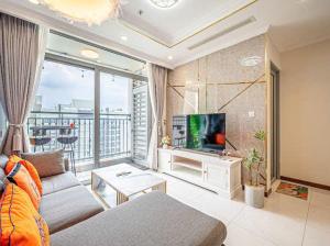 a living room with a couch and a tv at SG lusxury city in Ho Chi Minh City