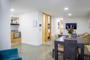 a dining room and kitchen with a table and chairs at Edificio Helena in Medellín +99 photos