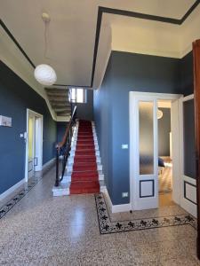 a staircase in a home with blue walls and a red carpet at Villa Cedro in Verbania