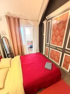 a bedroom with a bed with a red blanket and a window at 1 Camera Dubla Valea Trandafirilor in Chişinău