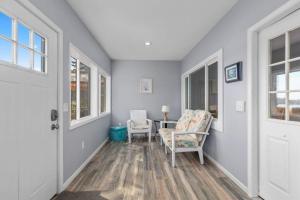 a hallway with a table and chairs in a house at 2 Lakefront Cottages with Docks, Bikes, BBQ in Newaygo