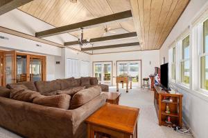 a living room with a couch and a table at 2 Lakefront Cottages with Docks, Bikes, BBQ in Newaygo