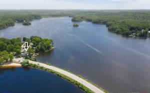 an aerial view of a large lake with a house at Pet-friendly Cabin with Dock, Firepit, BBQ in Newaygo