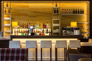 a bar with four chairs in front of a counter at Parkhotel Cochem- Free Parking - in Cochem