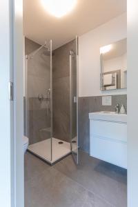 a bathroom with a shower and a toilet and a sink at Parkhotel Cochem- Free Parking - in Cochem