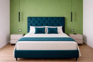 a large bed with a blue headboard in a bedroom at Le Chiavi di Polidoro in Aversa