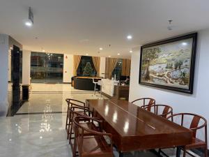 a dining room with a wooden table and chairs at Lạng Sơn Marina Hotel in Lạng Sơn