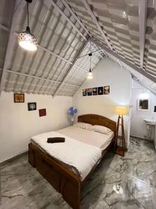 a bedroom with a bed and a sink at TauSco Homestay & Campsite - Coorg in Madikeri