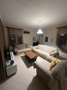 a living room with two couches and a coffee table at Happy Colors House Xanthi in Xanthi