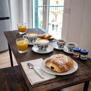 a table with a plate of pastry and cups of coffee at Le Chiavi di Polidoro in Aversa