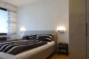 a bedroom with a bed with blue and white pillows at Fewo Lehner in Riedenburg