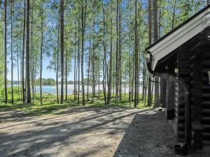 a cabin with a view of a lake and trees at Holiday Home Tavintupa by Interhome in Pertunmaa