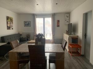 a living room with a table and a couch at Marieno in Barbâtre
