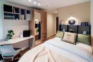 a bedroom with a bed and a desk and a chair at The Artisan - City Centre in Dublin